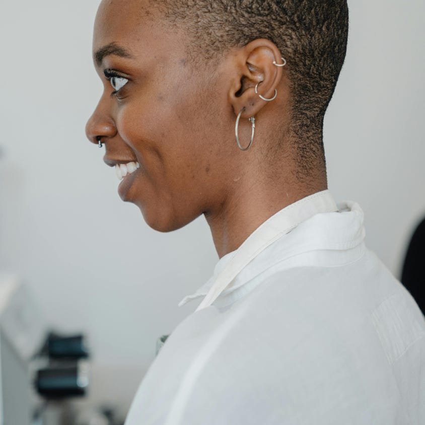 Cheerful young black woman during work in coffee house