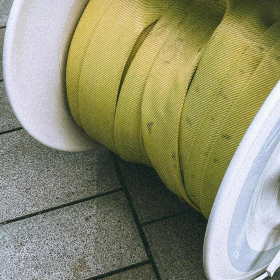 Close-up of Industrial Water Hose Reel on Pavement