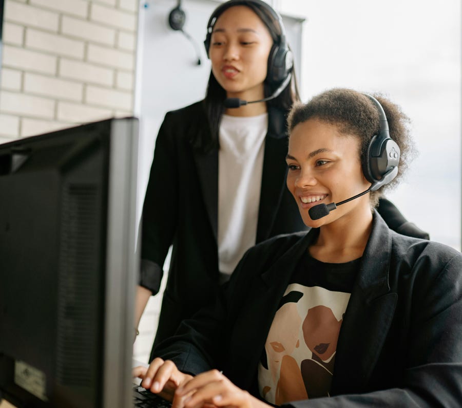 Two Women With Headsets Working As Call Center Agents